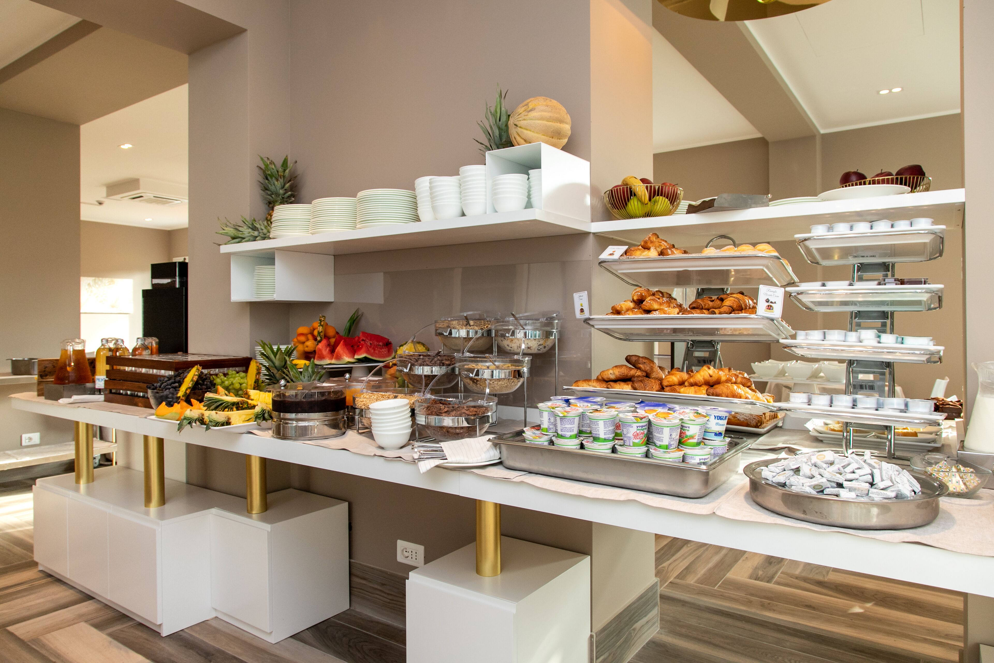 A buffet setup with various food items and beverages.