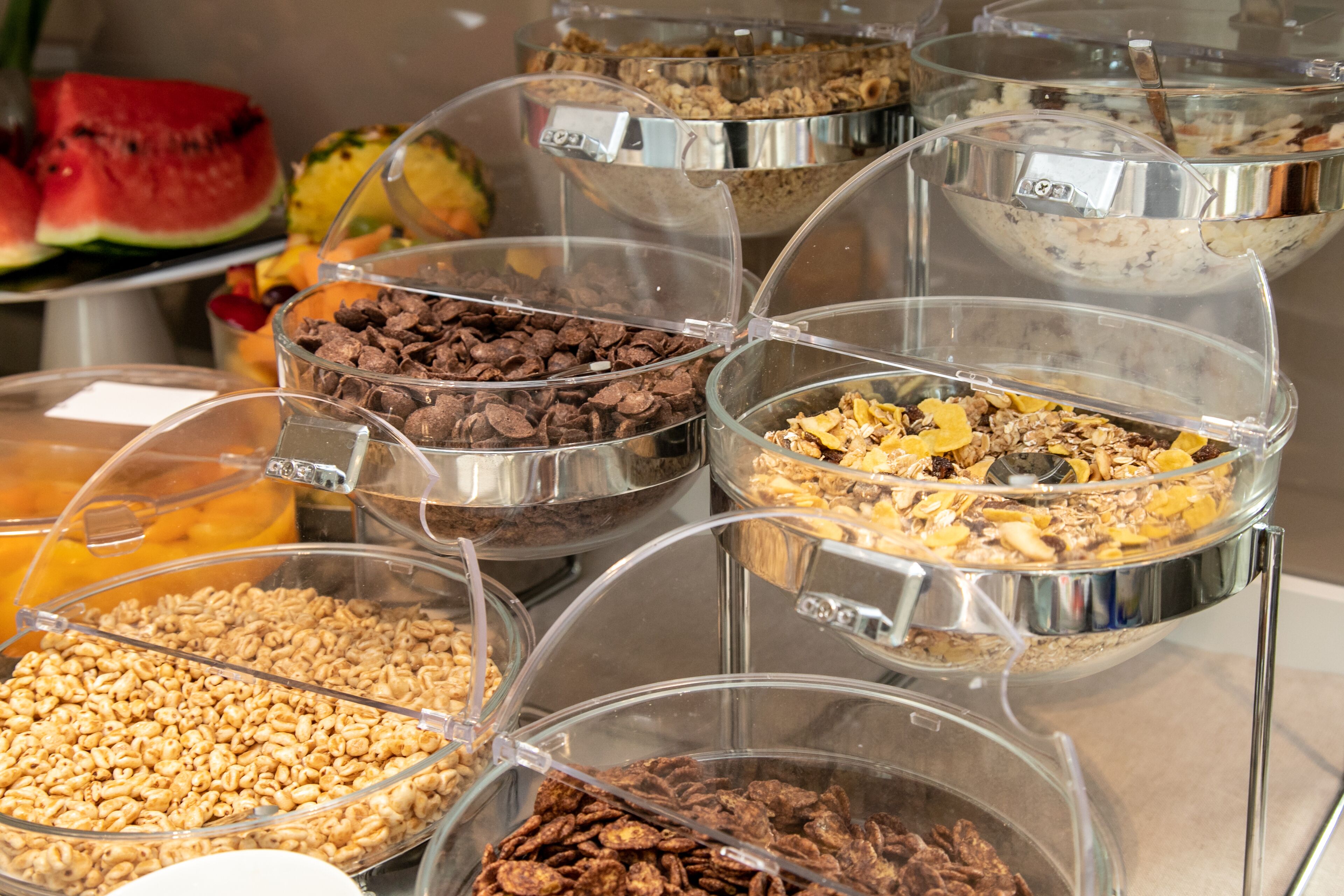 A buffet with various food items in clear containers.
