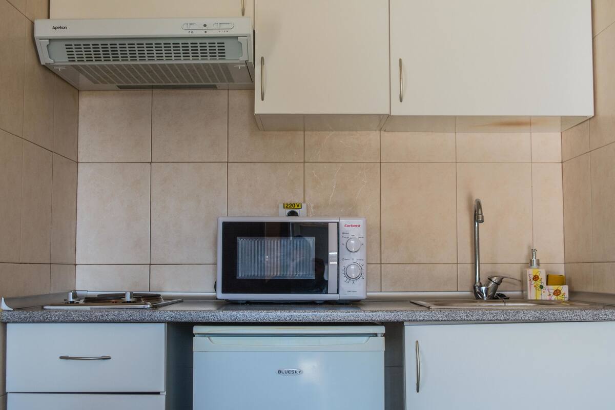 Fridge, microwave, cookware/dishes/utensils