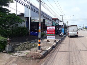 A street with a building that has multiple signs, including one for a nail spa. - Bandung Grand (Ban Dung)