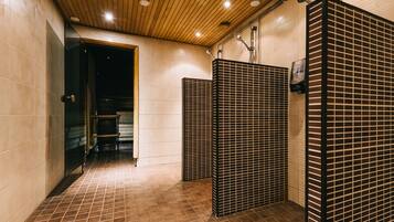 Bathroom features a shower area with a glass partition and a hand dryer.