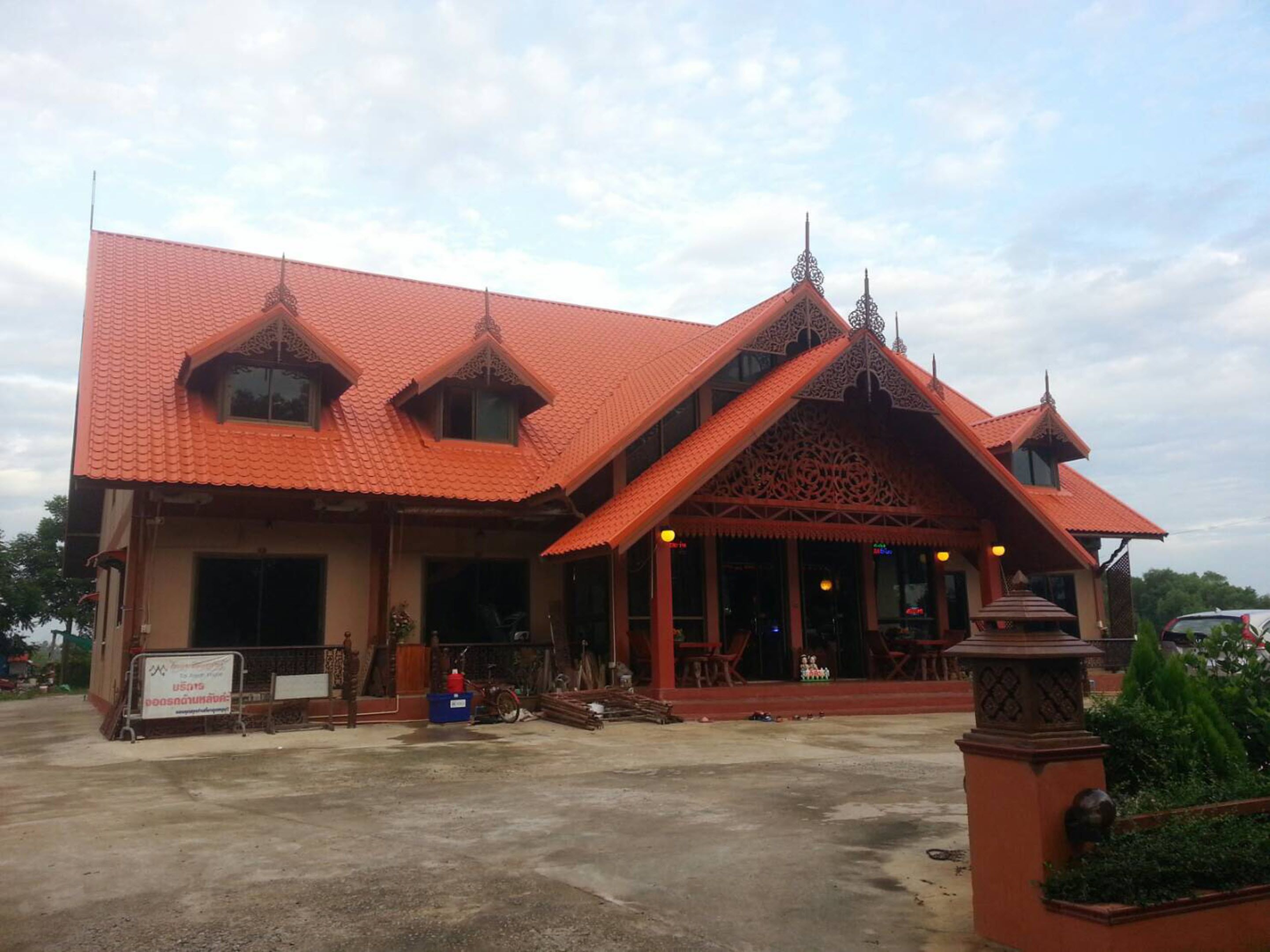 A traditional building with a red tiled roof and ornate architectural details.