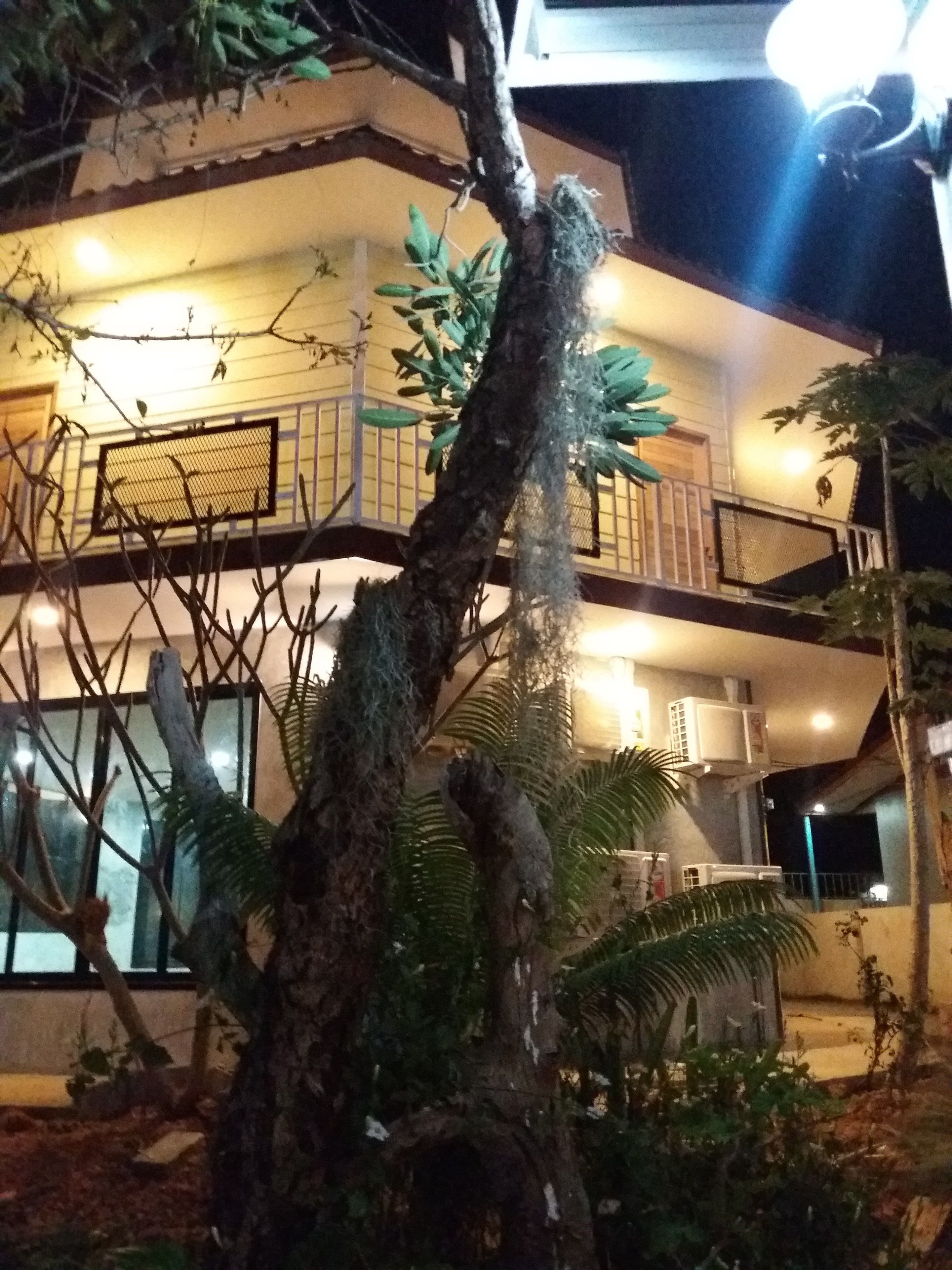 A multi-story building with balconies and air conditioning units.