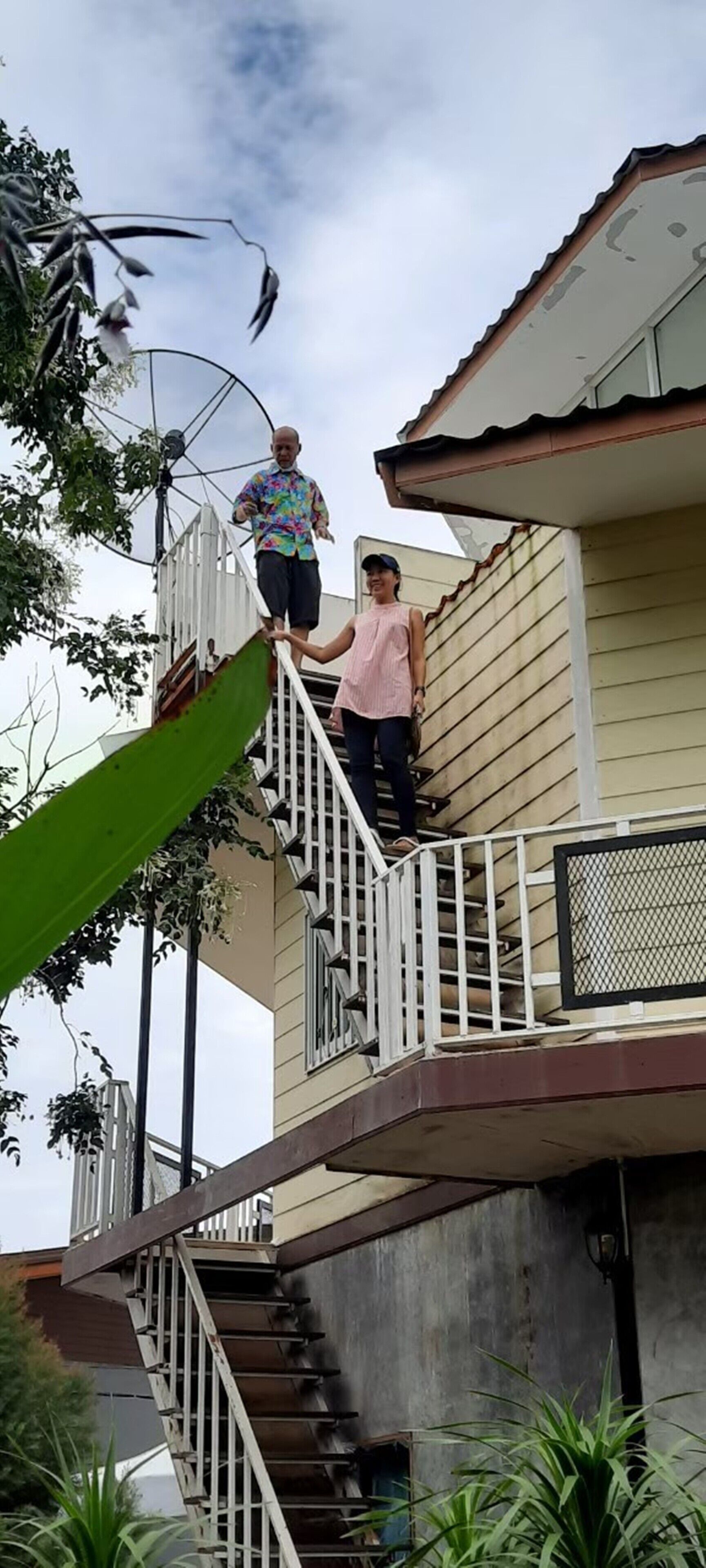 A residential building with a staircase leading to a balcony.