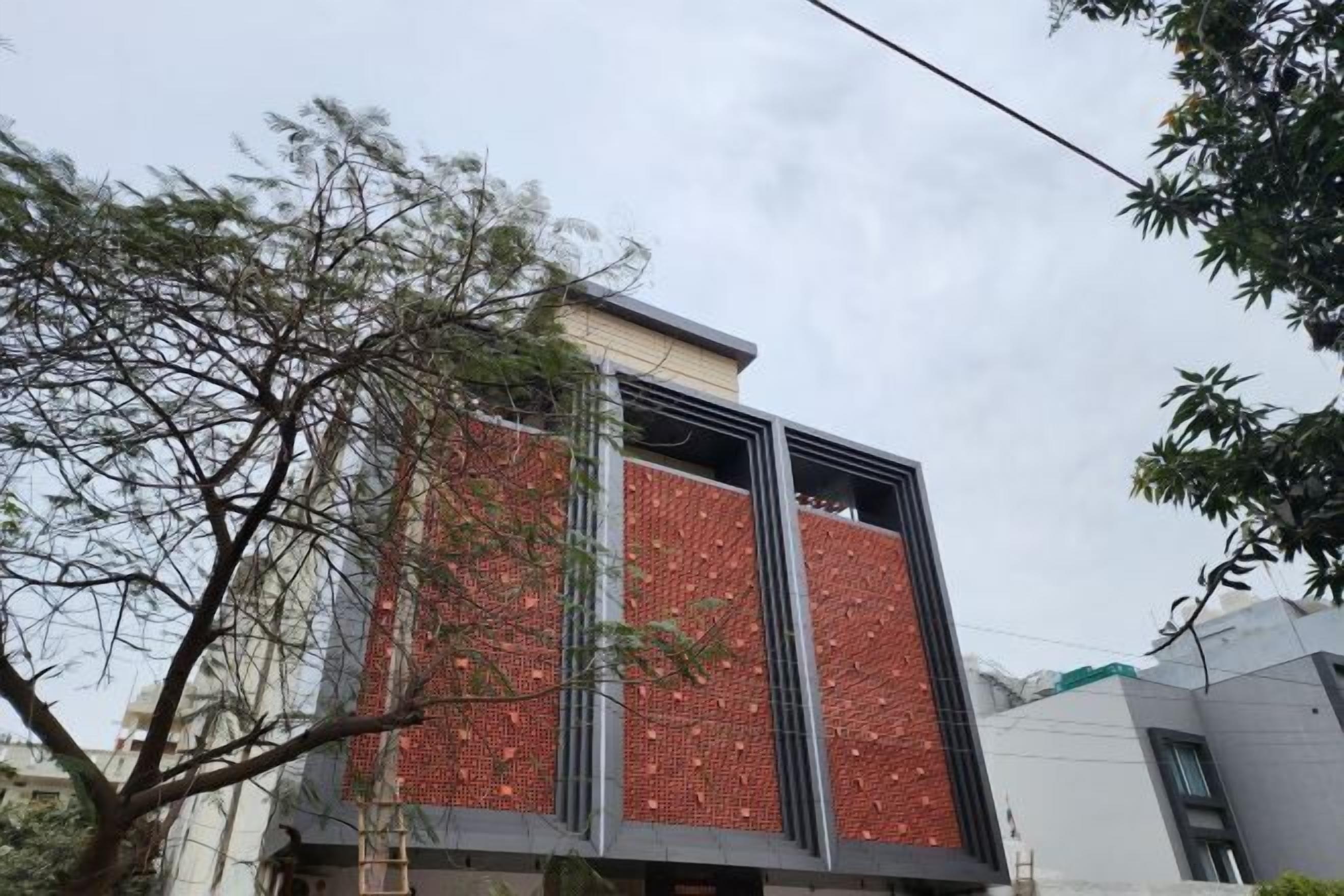 A modern building with a vertical brick facade and large windows.