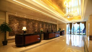 A spacious lobby with a polished marble floor, a reception desk, and a large decorative wall. - Lanxi International Hotel  (Xi'an)