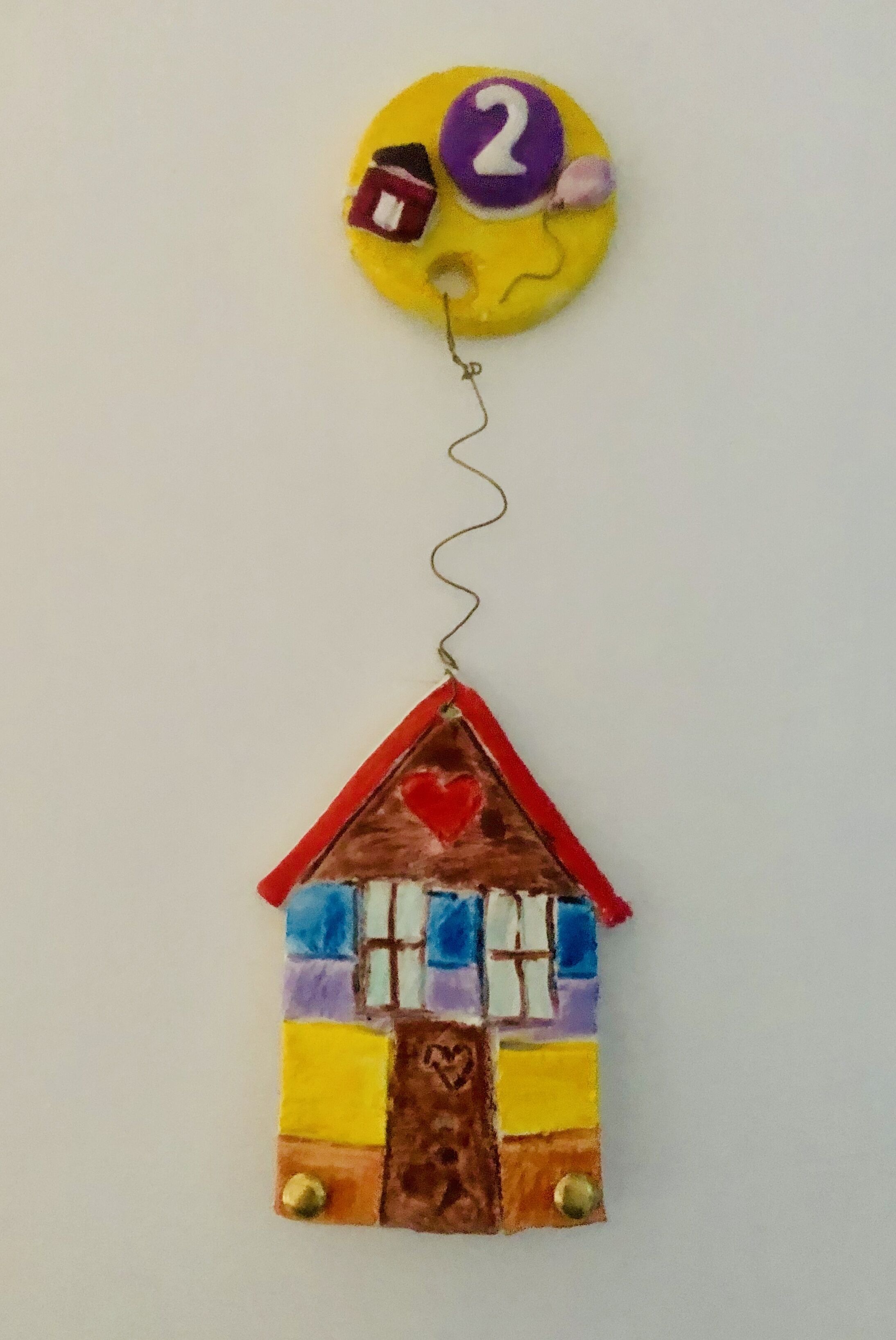 A colorful house-shaped keychain with a number 2 and a heart on it.