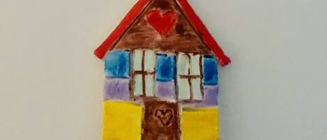 A colorful house-shaped keychain with a number 2 and a heart on it.