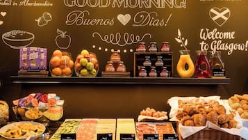 A breakfast buffet with various food items and a selection of juices.