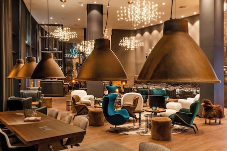 A modern interior with large pendant lights, leather seating, and a bar area.