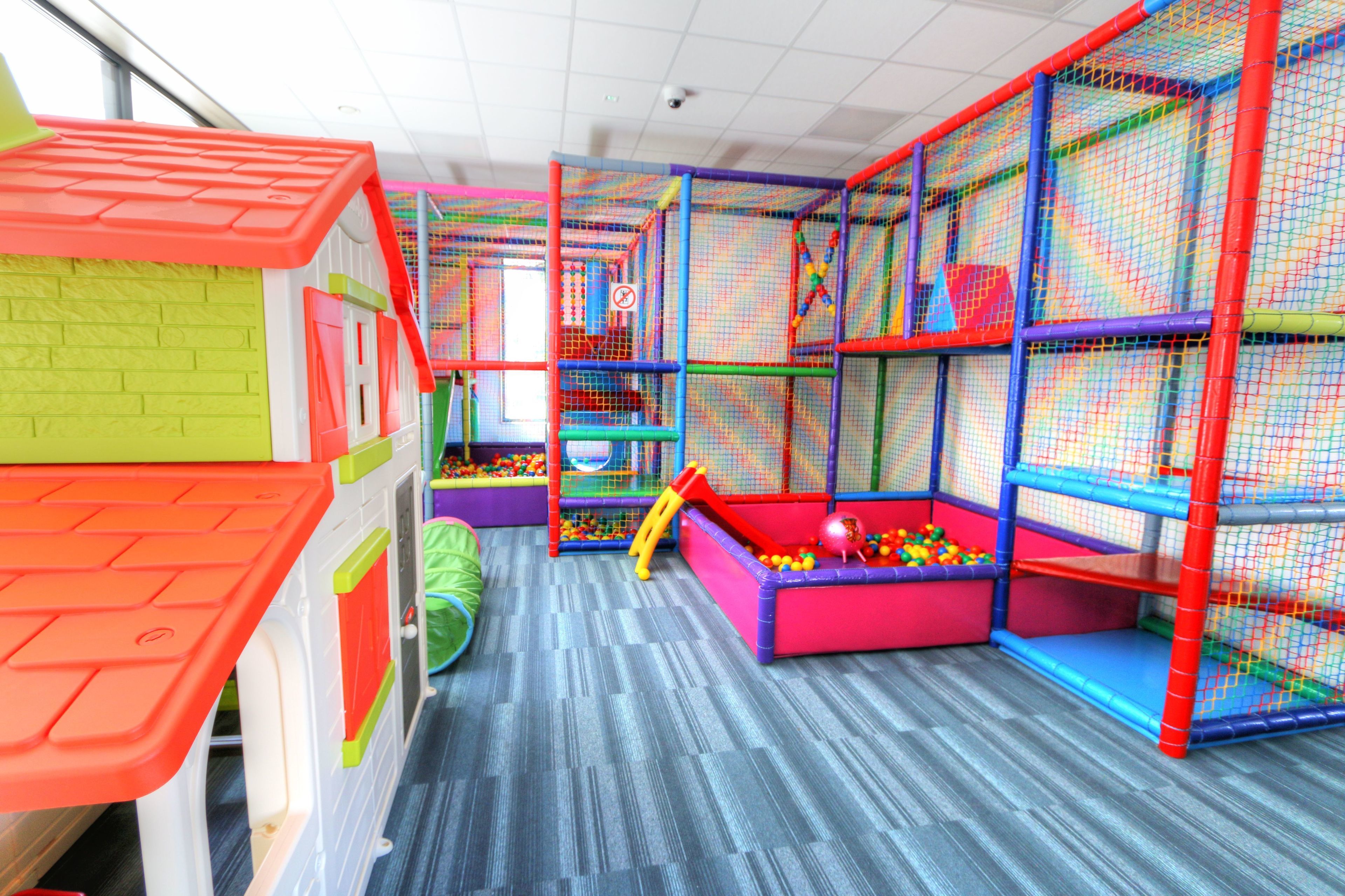 A children's play area with colorful play structures and a ball pit.