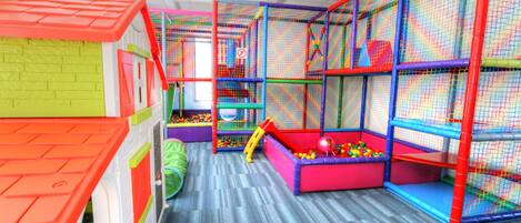 A children's play area with colorful play structures and a ball pit.