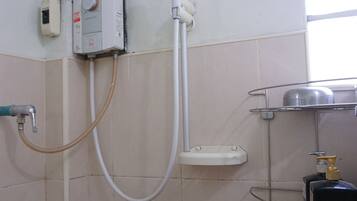 A bathroom with a shower, a toilet, and a sink.