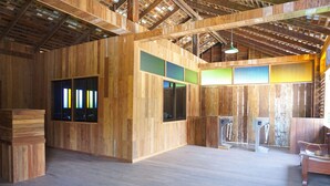 A spacious room with wooden walls and a sloped ceiling. - Phuruarounmai Resort (Phu Ruea)