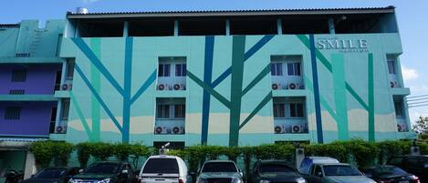 A building with a geometric facade and the name "SMILE" on the side.