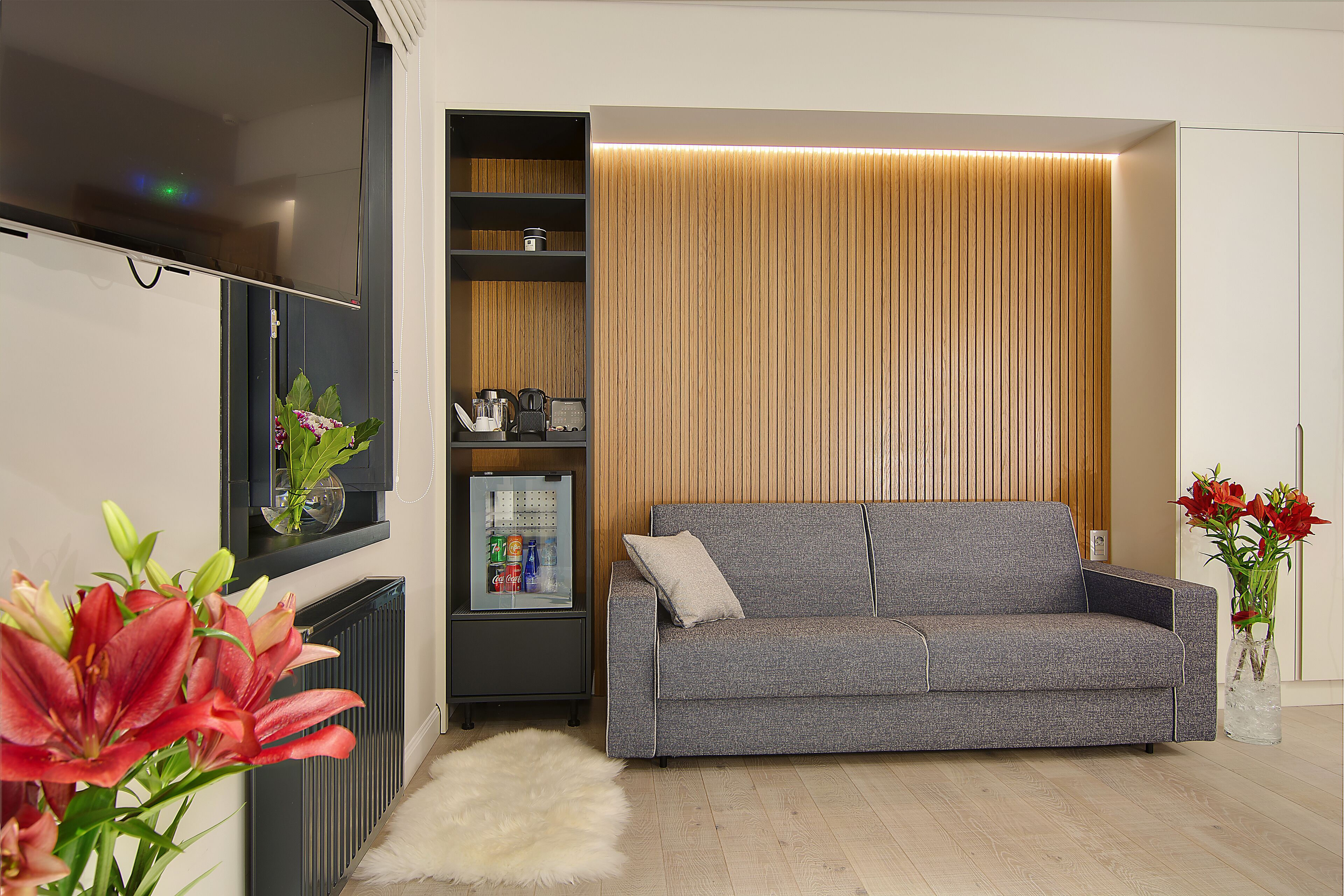 superior quadruple room, 1 king bed with sofa bed, mountain view | living area | 32-inch flat-screen tv with satellite channels, tv, dvd player