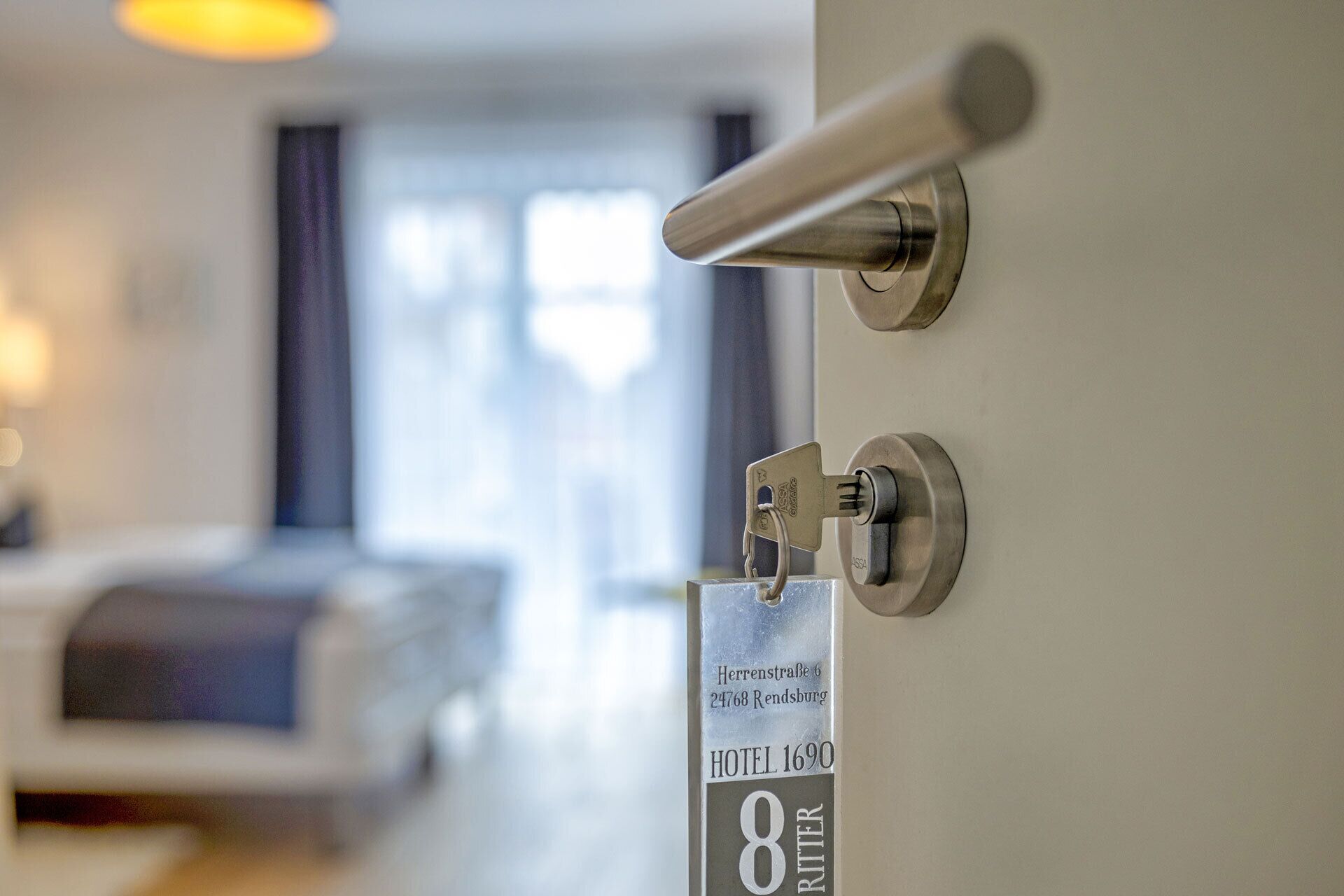 A hotel room door with a keyhole and a sign indicating room number 8.