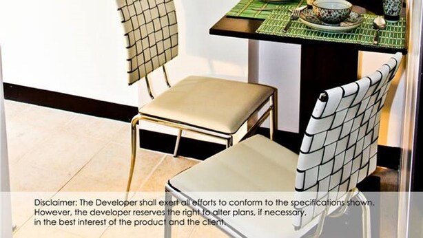 A modern kitchen with a dining area, featuring a large mirror, a dining table set with traditional Asian-style tableware, and two chairs with unique back designs. - 2F6 Wharton Bldg North Cambridge Condo (Baguio)