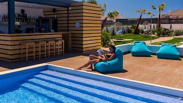 A poolside area with a bar, seating, and a view of the pool.