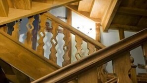 A wooden staircase with a unique wavy design.