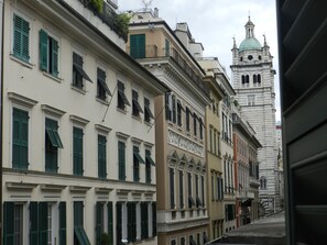 A row of historic buildings with traditional architecture, including a church with a dome and bell tower. - Bigo Guest House (Genoa)
