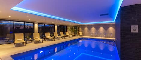 Indoor pool, pool umbrellas, pool loungers