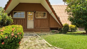 A wooden house with a pitched roof, a front door, and a small porch. - Saichonview Resort (Kanchanaburi)