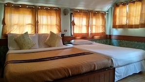 A double bed with a brown headboard and white bedding, two pillows, and a brown throw blanket. - Saichonview Resort (Kanchanaburi)