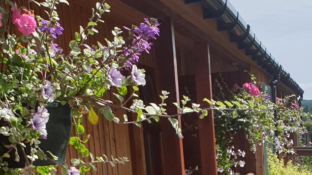 A wooden building with a sloped roof and a wooden railing. - Red Lion Inn (Wooler)