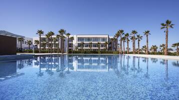 2 indoor pools, 2 outdoor pools, open 7:30 AM to 9:30 PM, pool umbrellas