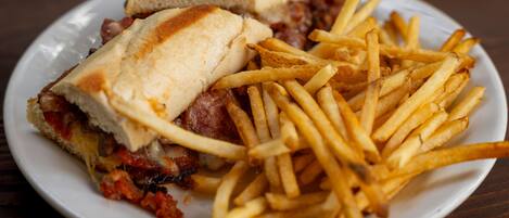 A plate with a sandwich and french fries.
