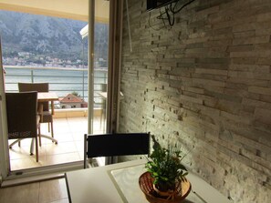 Studio, Sea View | Living area | Flat-screen TV
