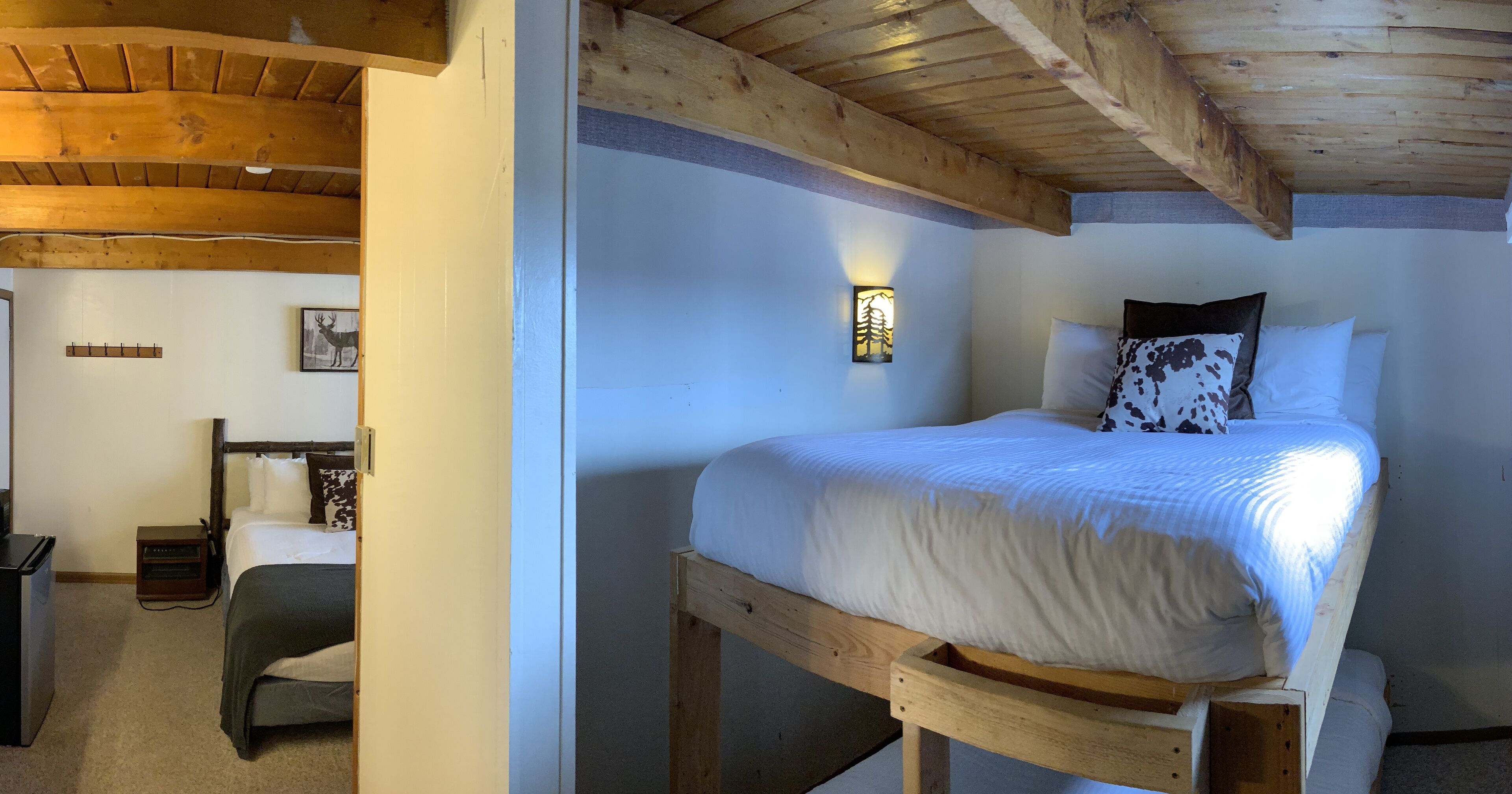 A single bed with a wooden frame, white bedding, and a wall-mounted light fixture.