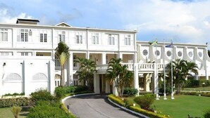 A large, white colonial-style building with multiple balconies and a curved driveway. - Scarlett Guesthouse Hotel Resorts (Bull Bay)