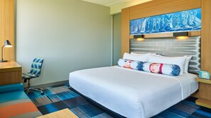 A hotel room with a large bed, a desk, a chair, and a wall-mounted artwork. - Aloft by Marriott Dallas Arlington Entertainment District (Arlington)