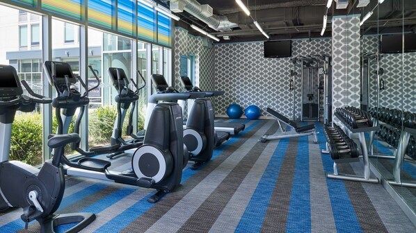 A gym with treadmills, elliptical machines, and weightlifting equipment. - Aloft by Marriott Dallas Arlington Entertainment District (Arlington)