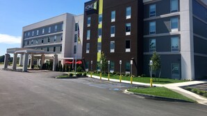 A multi-story hotel with a modern design, featuring a prominent 'HOME 2' sign on the facade. - Home2 Suites by Hilton Queensbury Lake George (Queensbury)