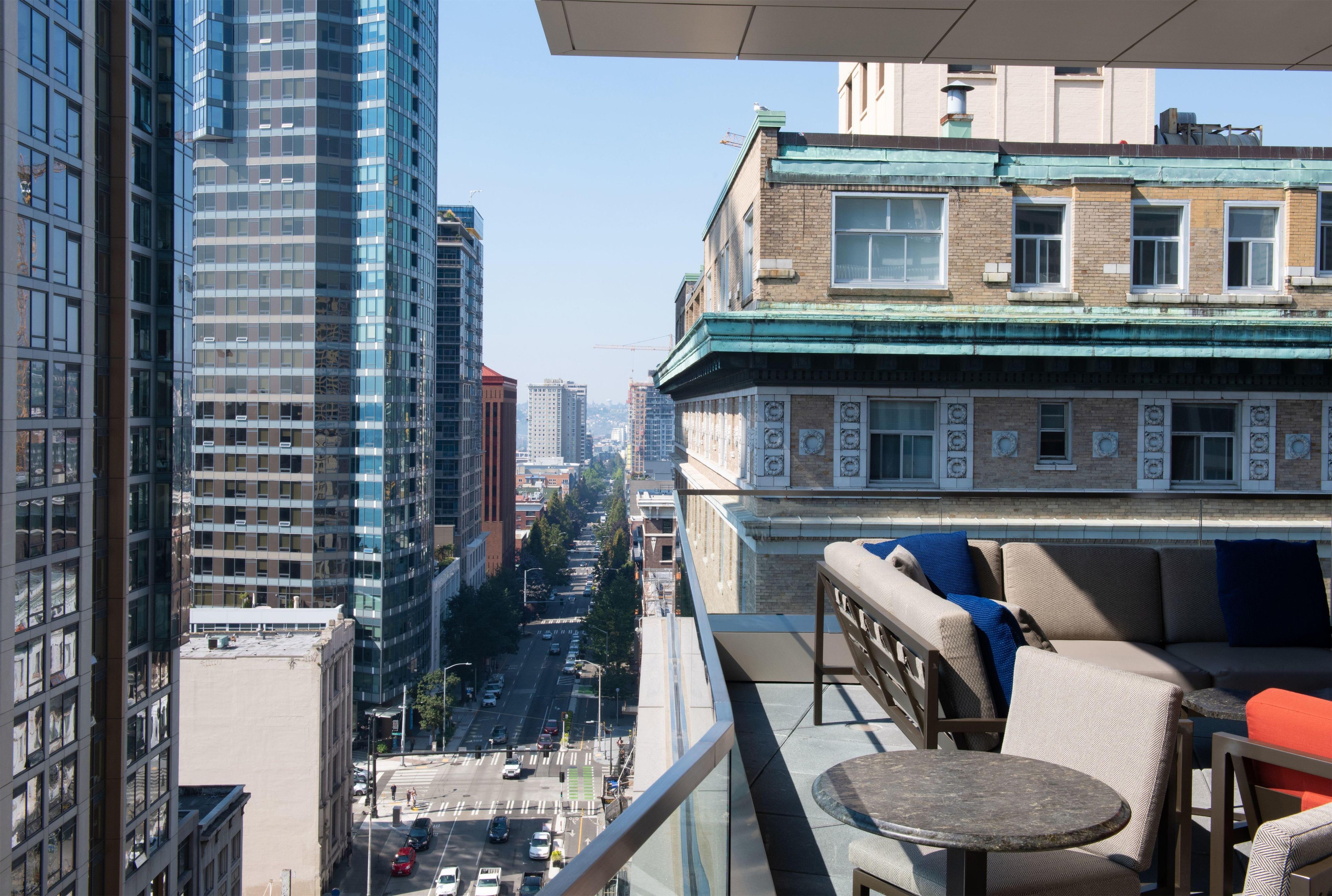 A high-rise building with a view of a city street below.