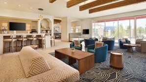 A modern hotel lobby with a large seating area, a bar, and a television. - Residence Inn by Marriott Phoenix Chandler/South (Chandler)