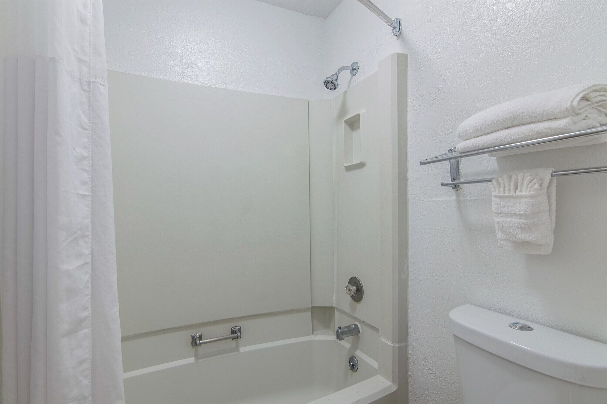 A bathroom with a bathtub, a shower, and a toilet.