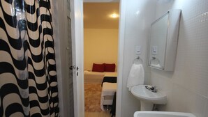 A bathroom with a white sink, a mirror, and a shower curtain. - GoHouse Djalma 519 (Rio de Janeiro)