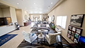 A spacious lobby with a reception desk, seating area, and a fireplace. - Cobblestone Inn & Suites - Clarinda (Clarinda)