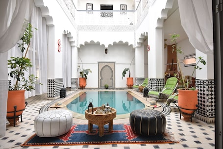 Indoor pool, open 10:00 AM to 8:00 PM, pool loungers. Hotel Riad Amlal