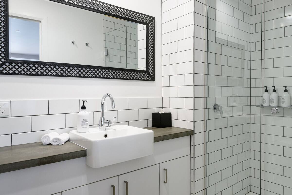 motel suites | bathroom | shower, rainfall showerhead, designer toiletries, hair dryer