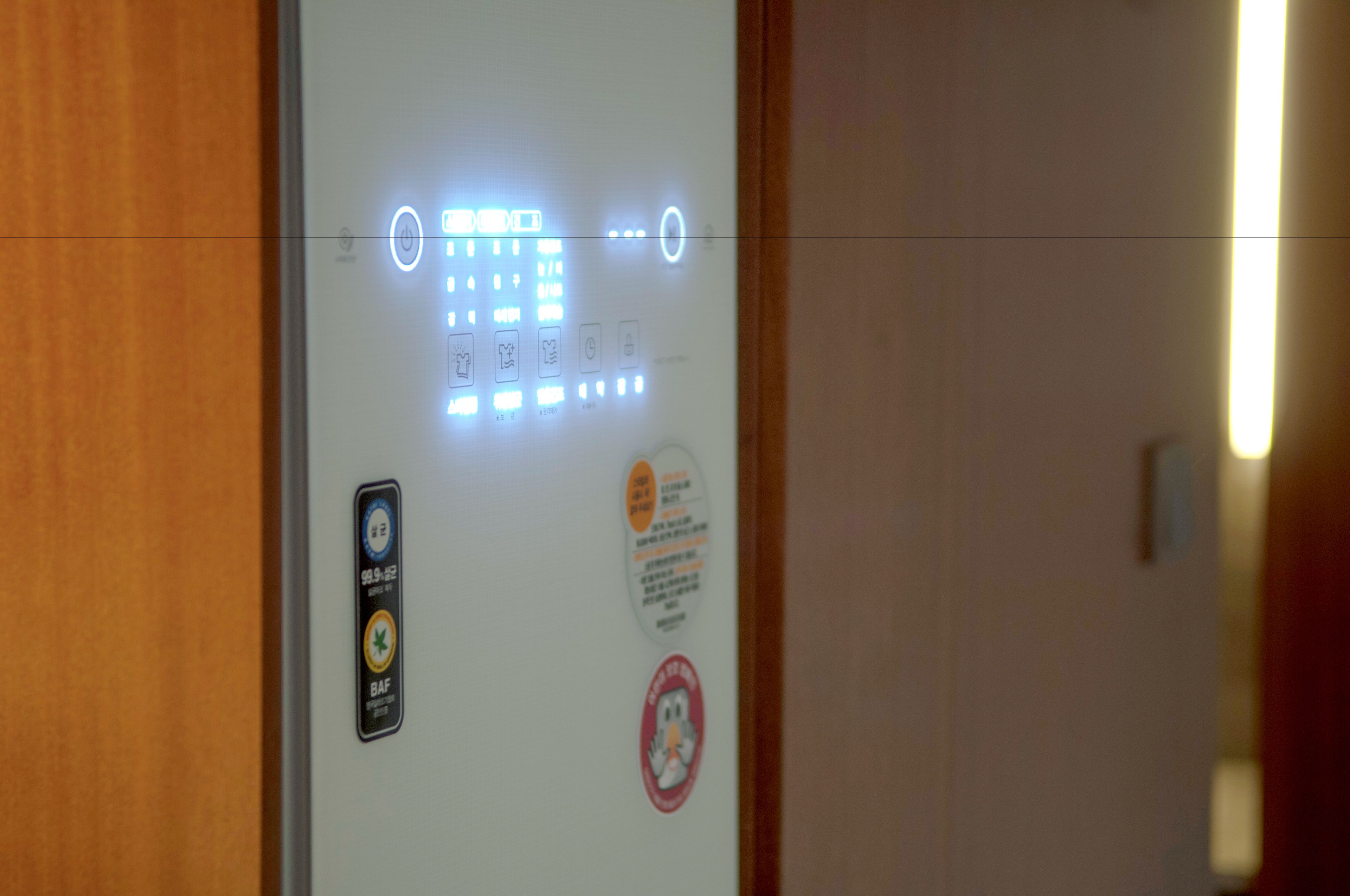 An elevator control panel with illuminated buttons and a digital display.