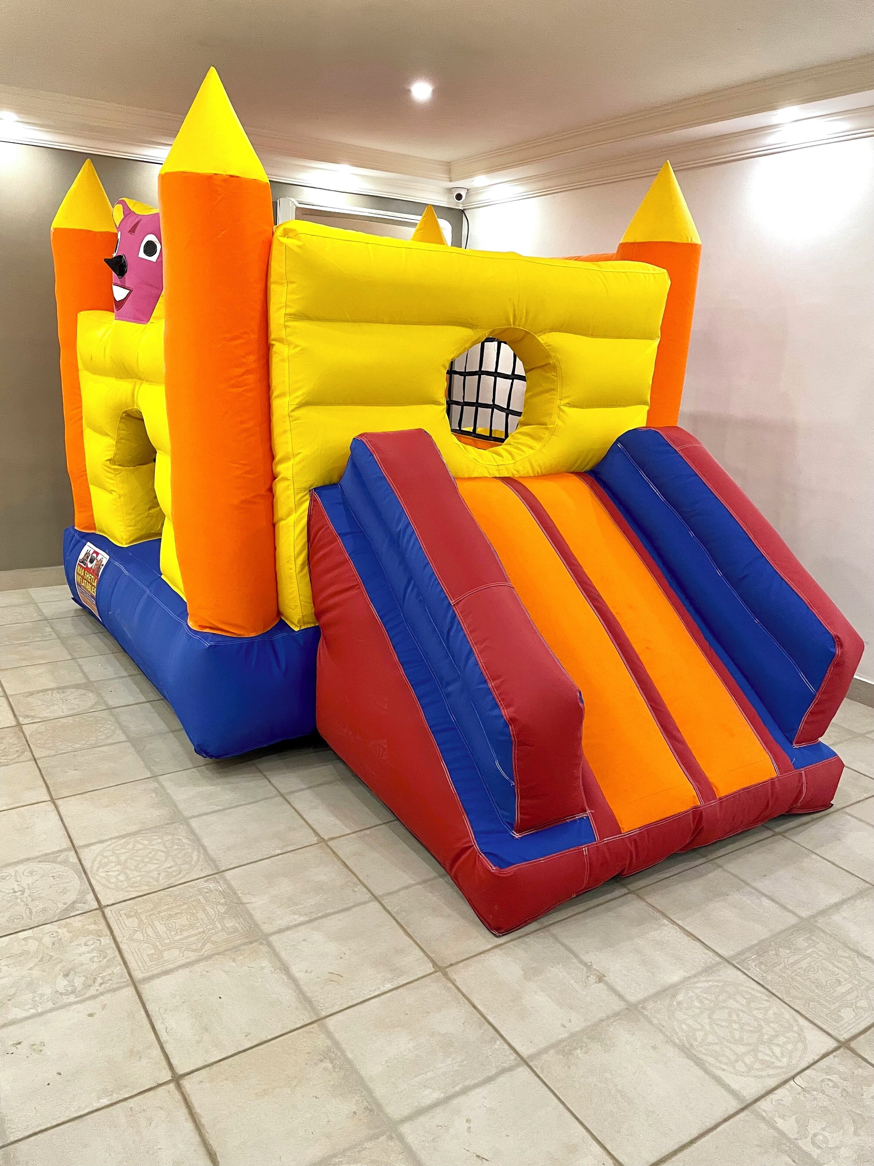 An inflatable play area with a slide and a tunnel.