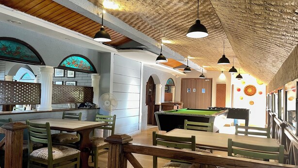 A billiards room with wooden tables and chairs, a pool table, and a ceiling with a woven pattern. - Ziva Suites - A Boutique Hotel (Siolim)
