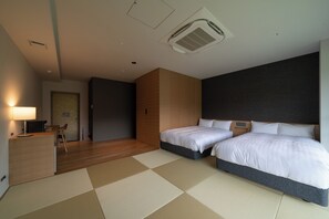 A hotel room with two beds, a desk with a chair, a lamp, and a large window. - Okutamaji (Ome)