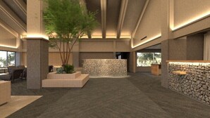 A spacious lobby with a central seating area, a stone wall, and a reception desk. - Okutamaji (Ome)