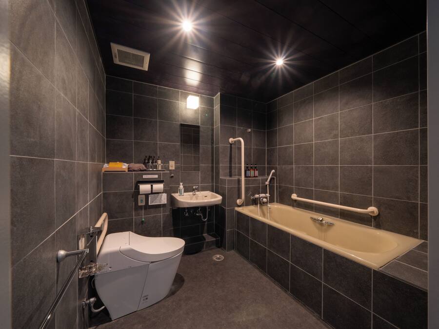 Une salle de bain moderne équipée de toilettes, d’un lavabo et d’une baignoire.